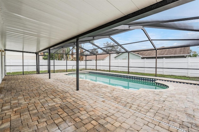 view of swimming pool with a patio and glass enclosure