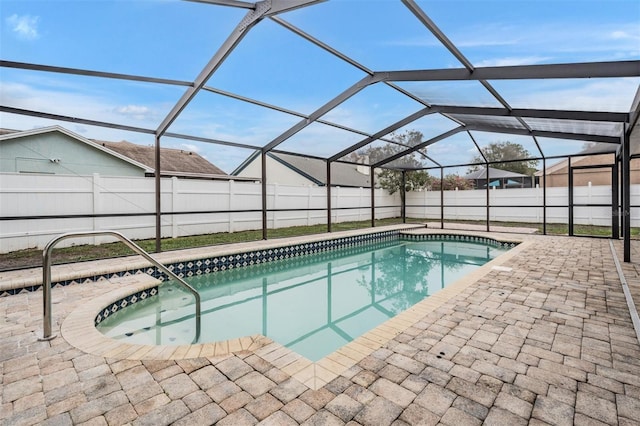 view of swimming pool featuring a patio and glass enclosure