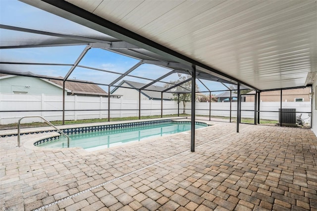 view of swimming pool with a lanai and a patio area