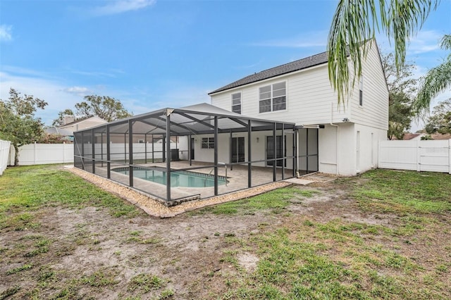 rear view of property with a fenced in pool, a yard, a patio, and glass enclosure