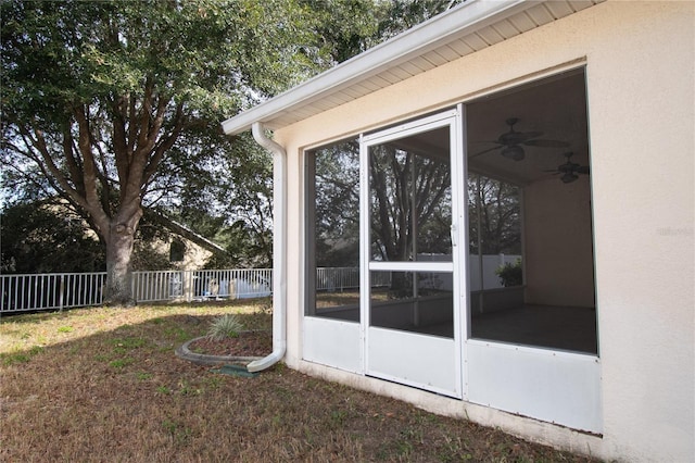 exterior space with a sunroom and ceiling fan