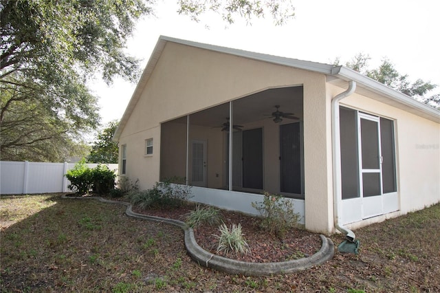 view of side of home featuring ceiling fan