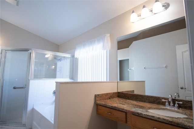 bathroom with vanity, vaulted ceiling, and shower with separate bathtub