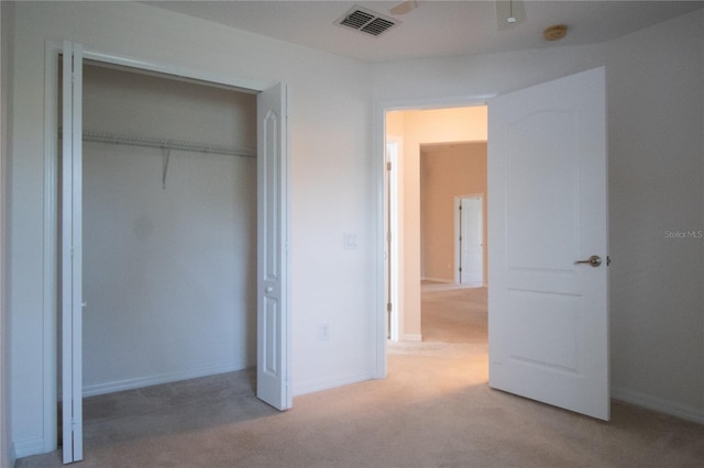 unfurnished bedroom featuring carpet floors and a closet