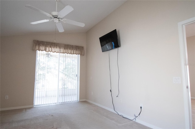 carpeted empty room with ceiling fan and lofted ceiling