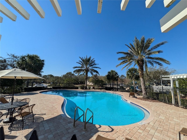 pool featuring a patio area, fence, and a pergola