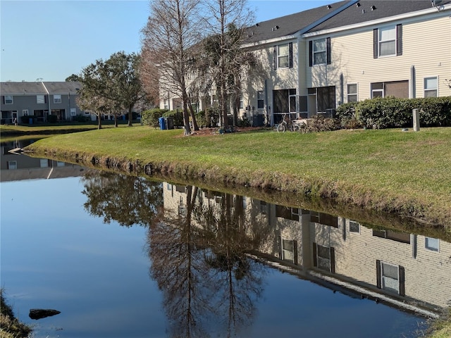 exterior space with a water view and a lawn