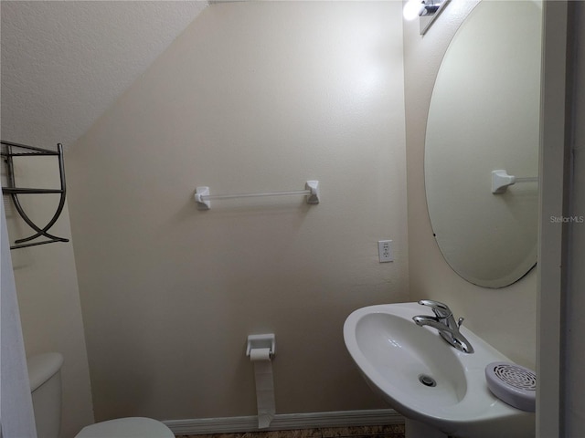 bathroom featuring toilet and a sink