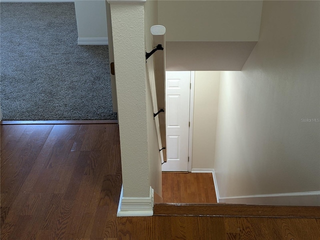 corridor with wood finished floors and baseboards