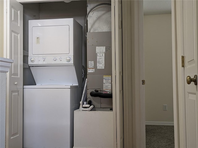 laundry room featuring stacked washer and dryer and laundry area