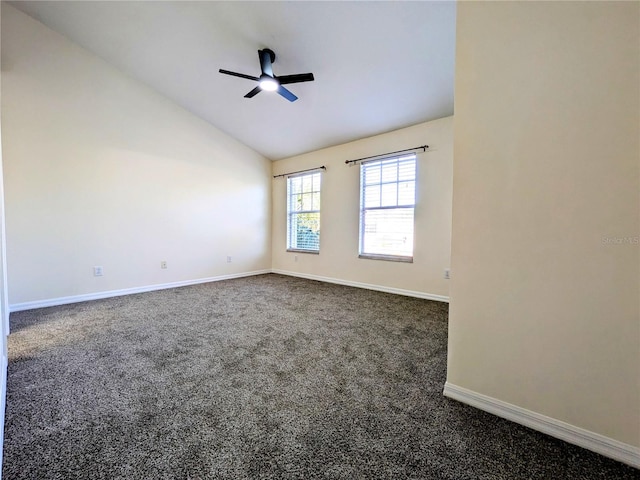 unfurnished room featuring ceiling fan, baseboards, vaulted ceiling, and dark colored carpet