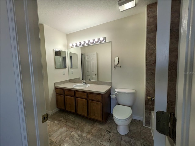 bathroom featuring toilet, a tub, vanity, and baseboards