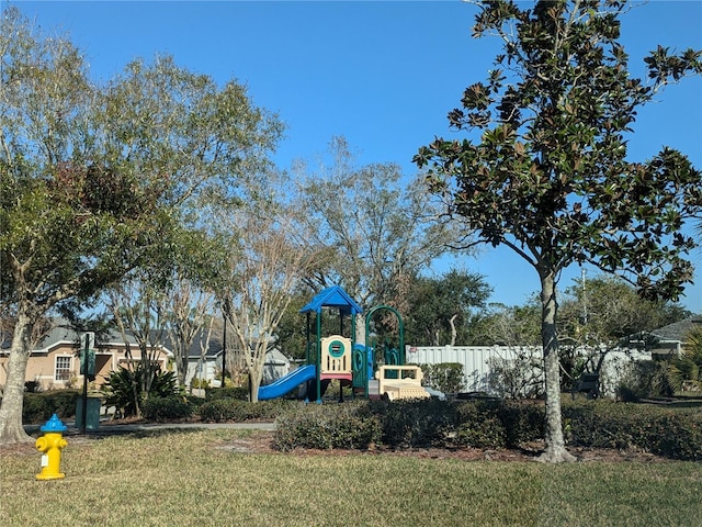 community playground featuring a yard and fence