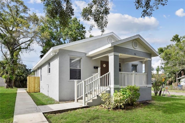 bungalow-style home with a porch and a front lawn