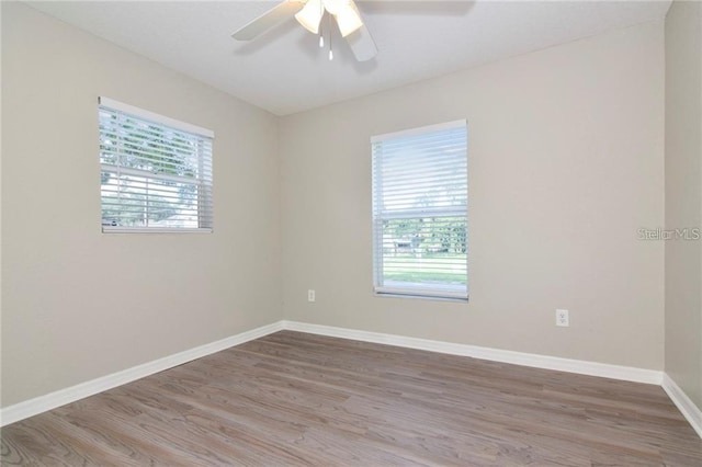 empty room featuring hardwood / wood-style floors and ceiling fan