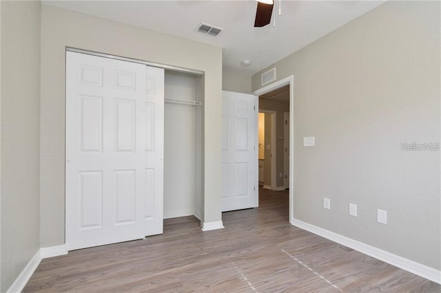 unfurnished bedroom with a closet, ceiling fan, and light wood-type flooring