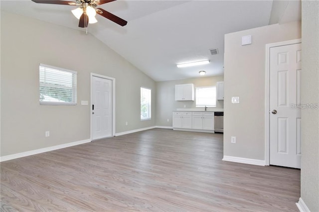 unfurnished living room with lofted ceiling, sink, light hardwood / wood-style flooring, and ceiling fan