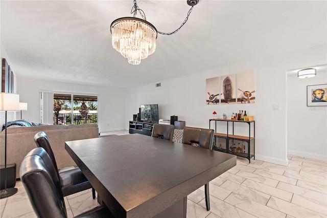 dining space featuring an inviting chandelier