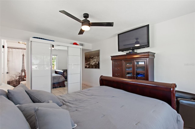 bedroom featuring ceiling fan, a closet, and ensuite bath