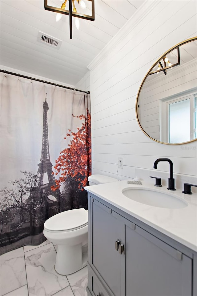 bathroom with vanity, crown molding, toilet, and wood walls