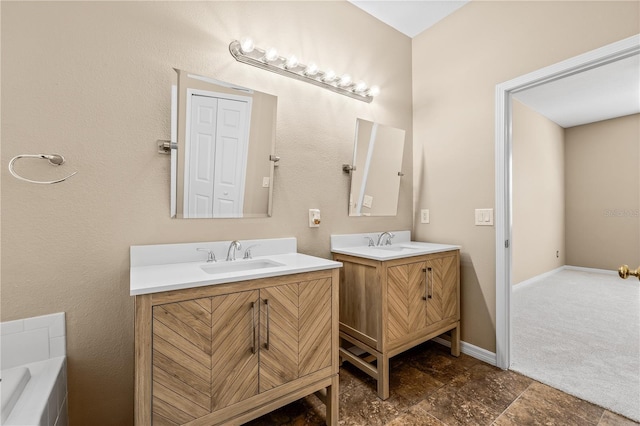 bathroom featuring vanity and a bath