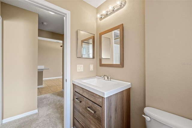 bathroom with vanity, tile patterned floors, and toilet