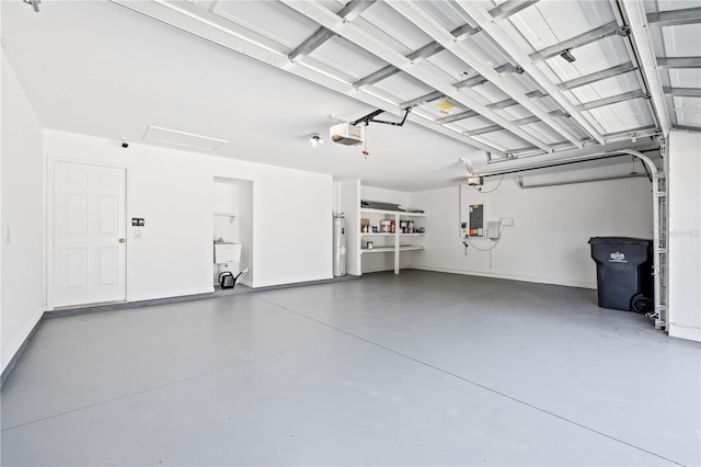 garage featuring a garage door opener, electric water heater, sink, and electric panel