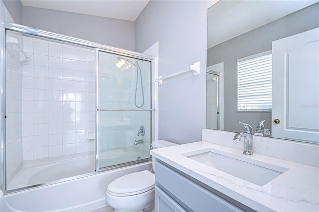 full bathroom with vanity, combined bath / shower with glass door, and toilet