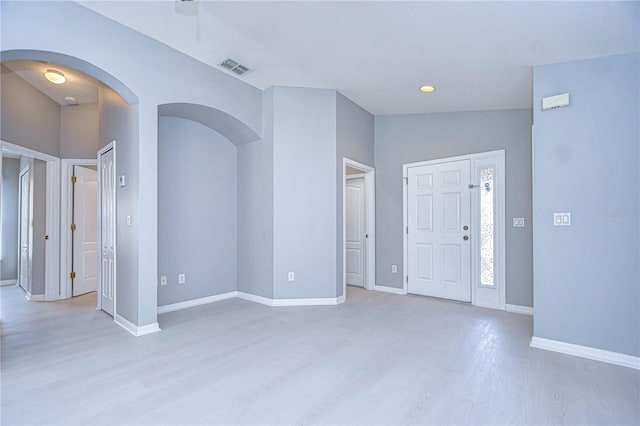 foyer featuring lofted ceiling and light hardwood / wood-style floors