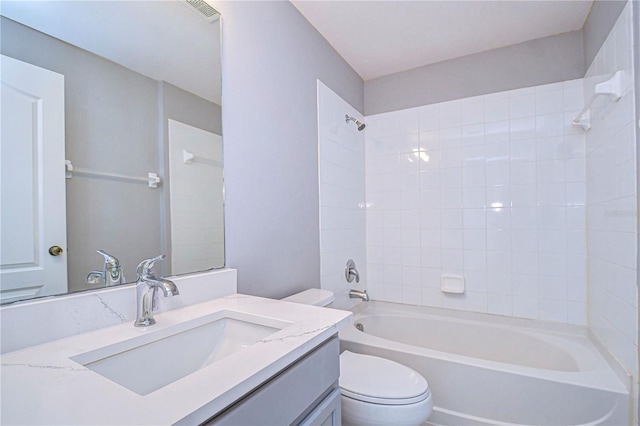 full bathroom with vanity, toilet, and tiled shower / bath