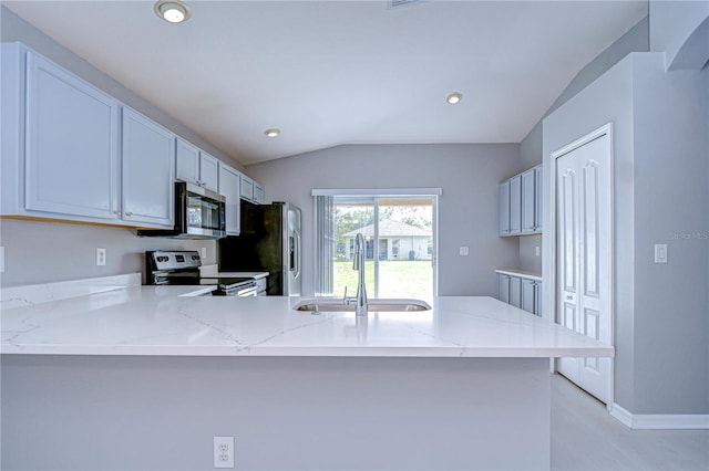 kitchen featuring vaulted ceiling, white cabinetry, sink, kitchen peninsula, and stainless steel appliances