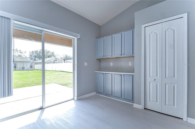 interior space with vaulted ceiling and light wood-type flooring