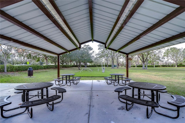 view of property's community with a yard and a patio area