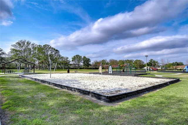 view of community with a yard, volleyball court, and a playground