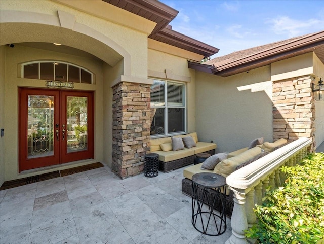 property entrance with a patio area and french doors