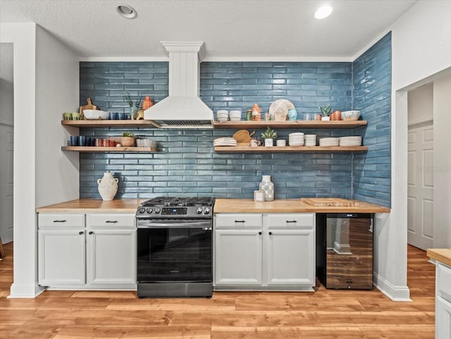 bar featuring light hardwood / wood-style floors, white cabinets, stainless steel range with gas cooktop, beverage cooler, and custom exhaust hood