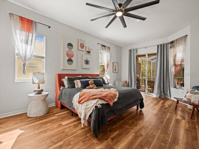 bedroom featuring ceiling fan, wood-type flooring, and access to exterior