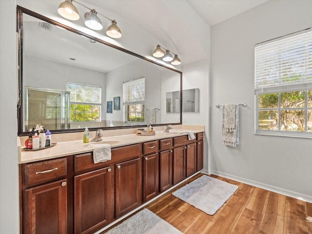 bathroom featuring an enclosed shower, wood-type flooring, and vanity