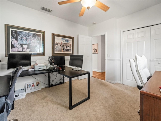 carpeted office with ceiling fan