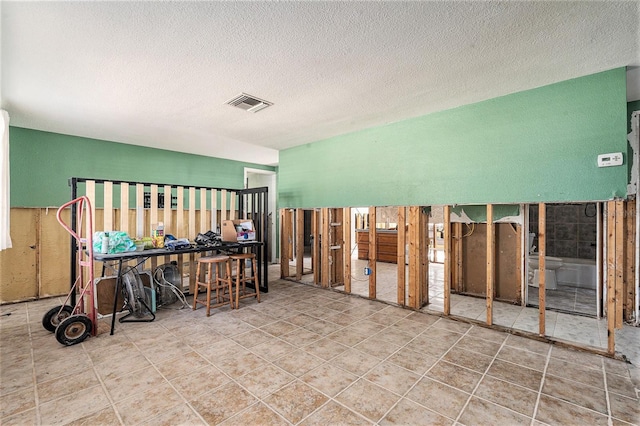 miscellaneous room featuring a textured ceiling