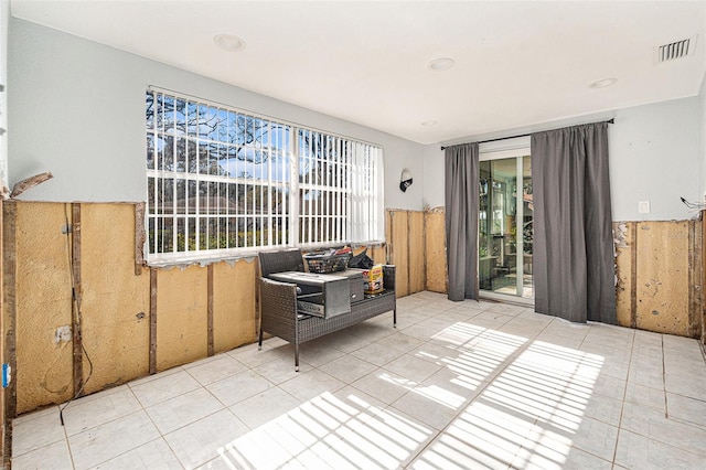 interior space featuring light tile patterned floors and wood walls