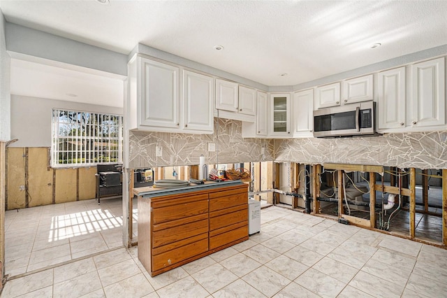 kitchen with white cabinets and backsplash