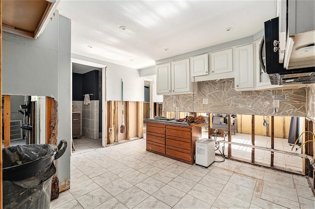 kitchen with white cabinetry and backsplash