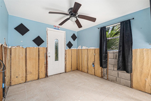 interior space with ceiling fan