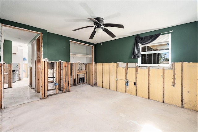 spare room featuring concrete floors and ceiling fan