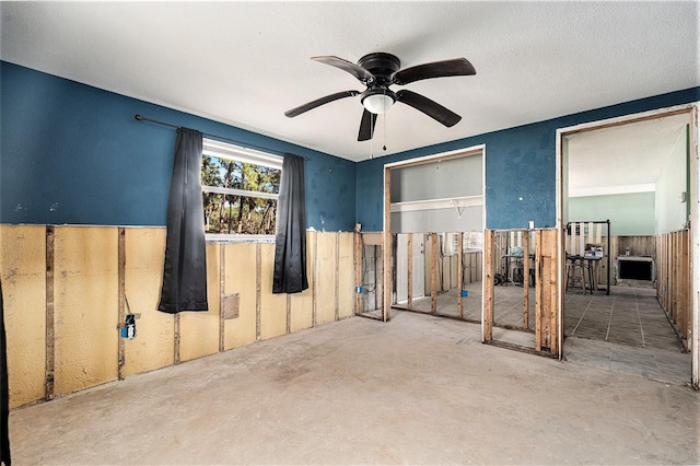 interior space with concrete flooring, a textured ceiling, and ceiling fan