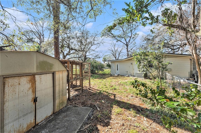 view of yard with an outbuilding and central AC