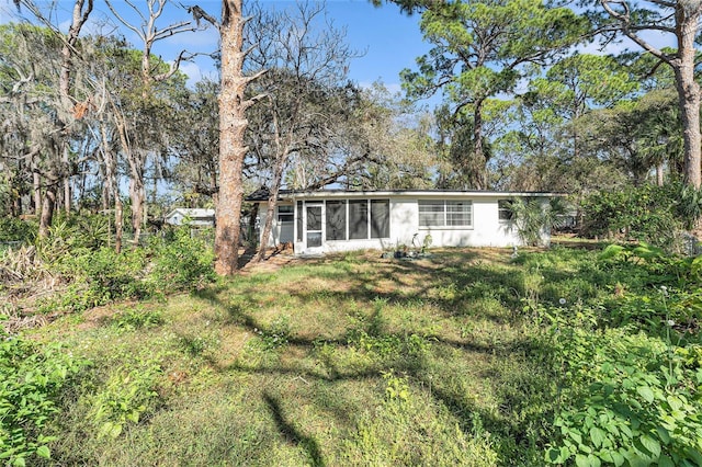 rear view of house with a lawn