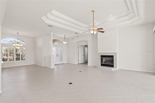 unfurnished living room with crown molding, a fireplace, and a raised ceiling