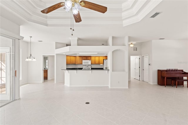 tiled living room featuring crown molding, ceiling fan, a raised ceiling, and a high ceiling